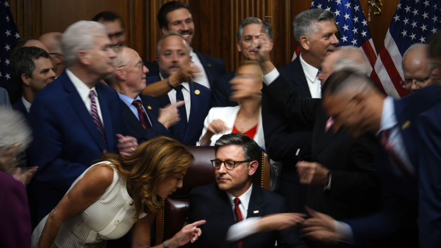 Speaker Johnson surrounded by people in motion